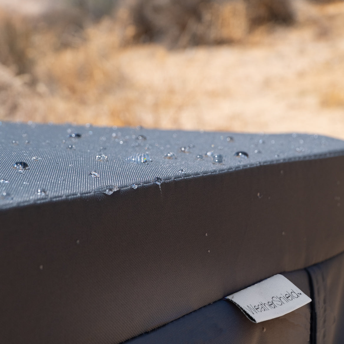 Close-up of water beading on woven WeatherShield spa cover fabric